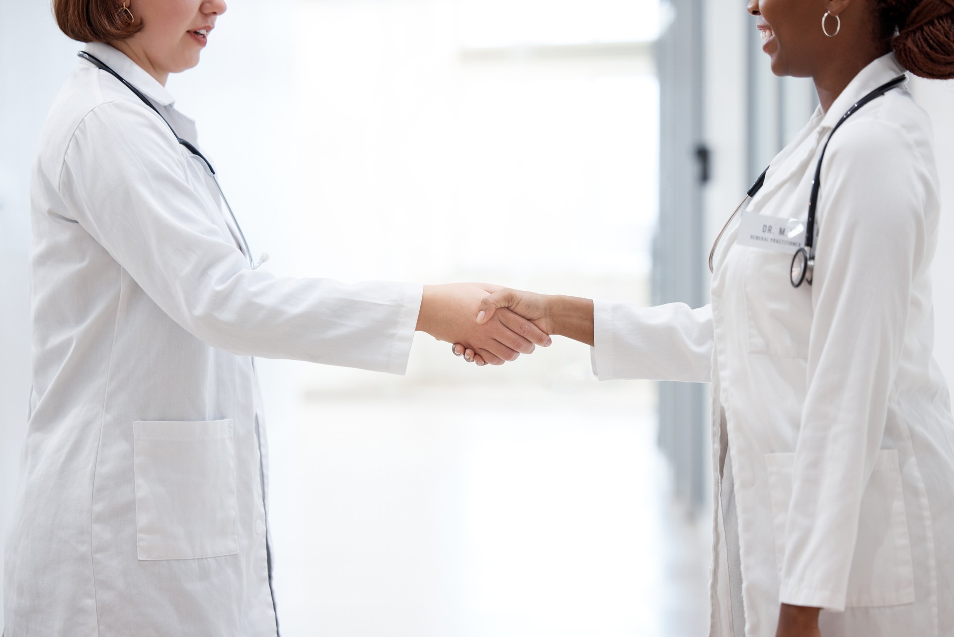 Shot of two doctors shaking hands in meeting